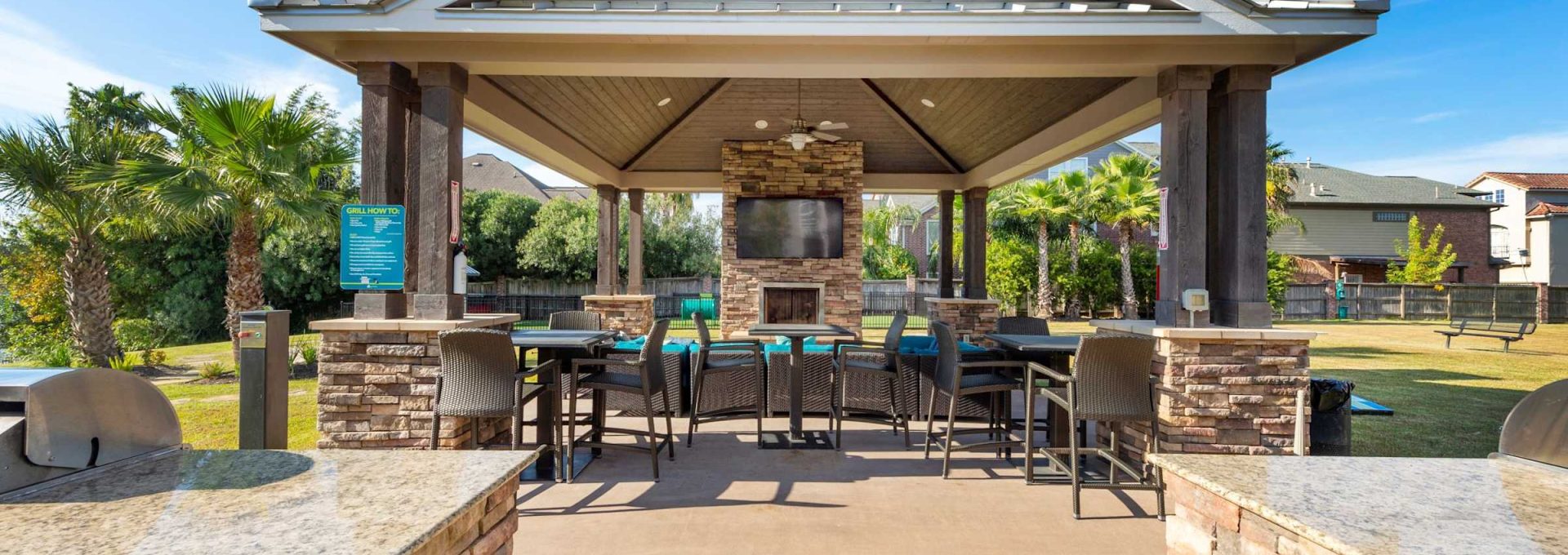 Waterfront picnic pavilion with gas grill and bar seating at Anchor at South Shore in League City, TX