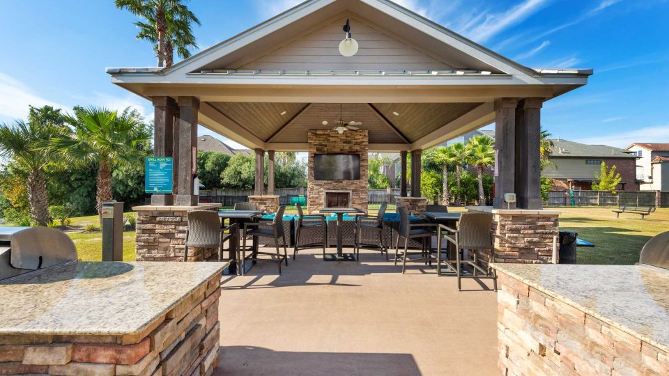 Waterfront picnic pavilion with gas grill and bar seating at Anchor at South Shore in League City, TX