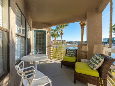 Private apartment balcony with cushioned seating overlooking the marina at Anchor at South Shore in League City, TX