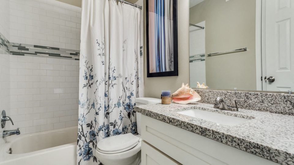 Bathroom with shower-tub combination and granite vanity at Clear Creek Landing in Houston, TX