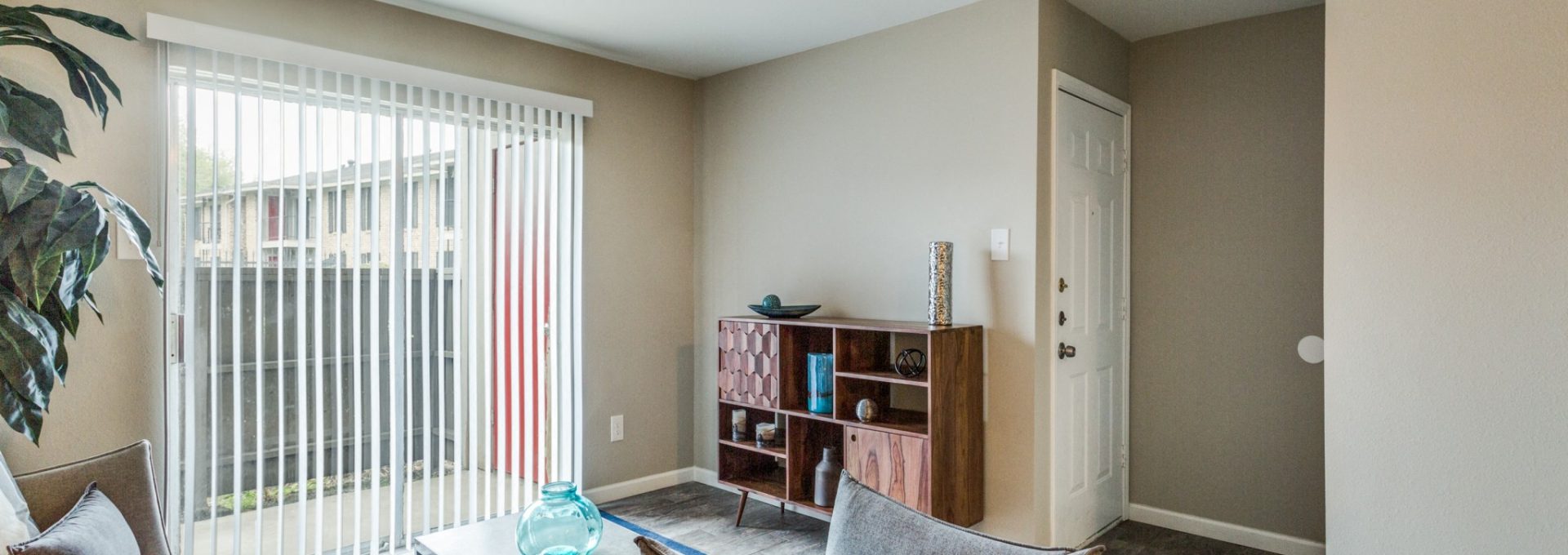 Bright staged living room with large window at Clear Creek Landing in Houston, TX