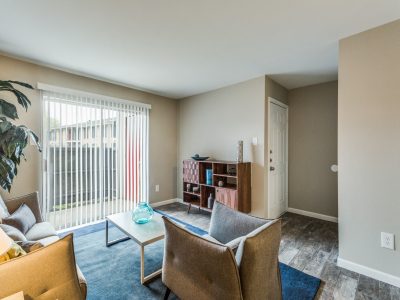 Bright staged living room with large window at Clear Creek Landing in Houston, TX
