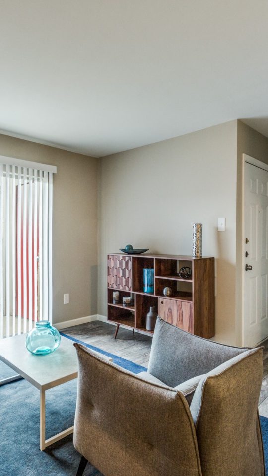 Bright staged living room with large window at Clear Creek Landing in Houston, TX