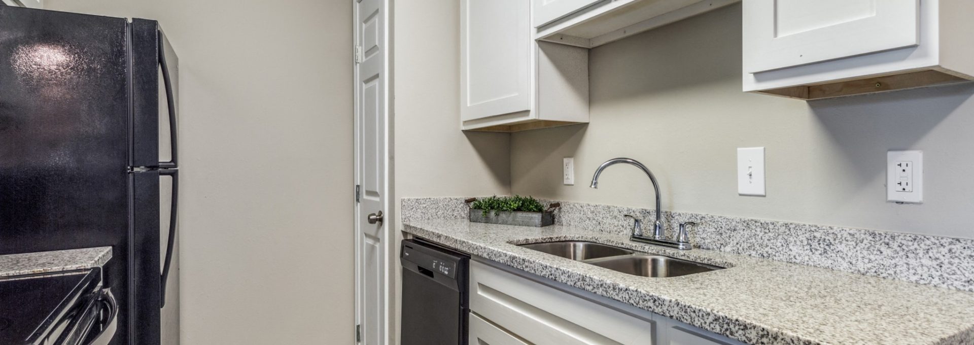 Kitchen with granite counters and generous cabinetry at Clear Creek Landing in Houston, TX