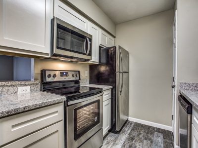 Kitchen with granite countertops and stainless steel appliances at Clear Creek Landing in Houston, TX