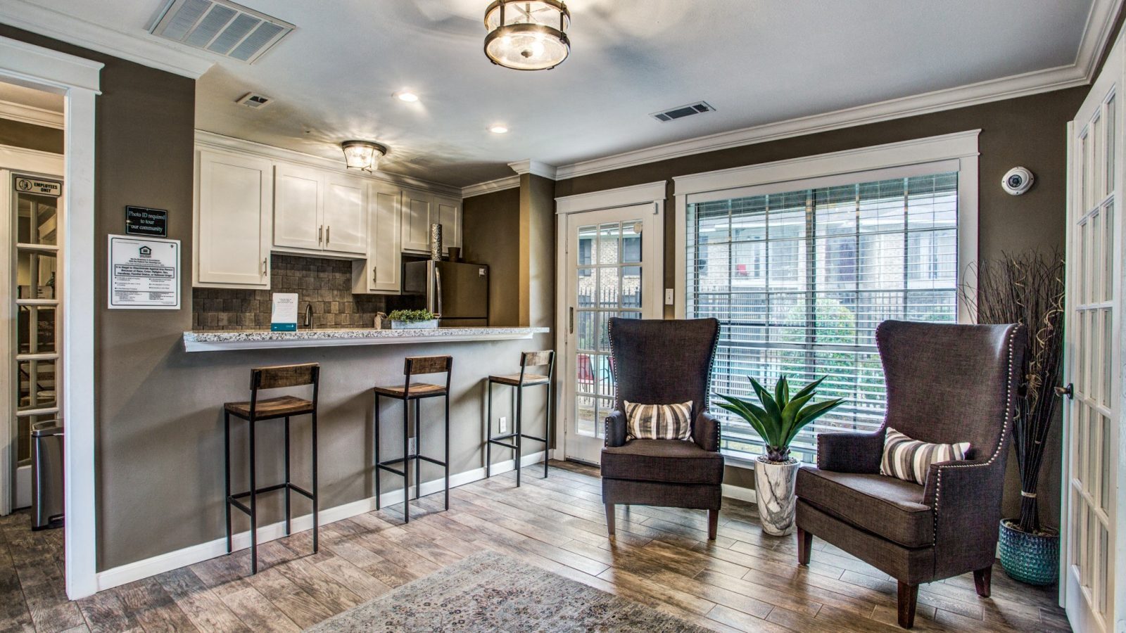 Renovated open-concept living room and kitchen with wood-style flooring at Clear Creek Landing in Houston, TX
