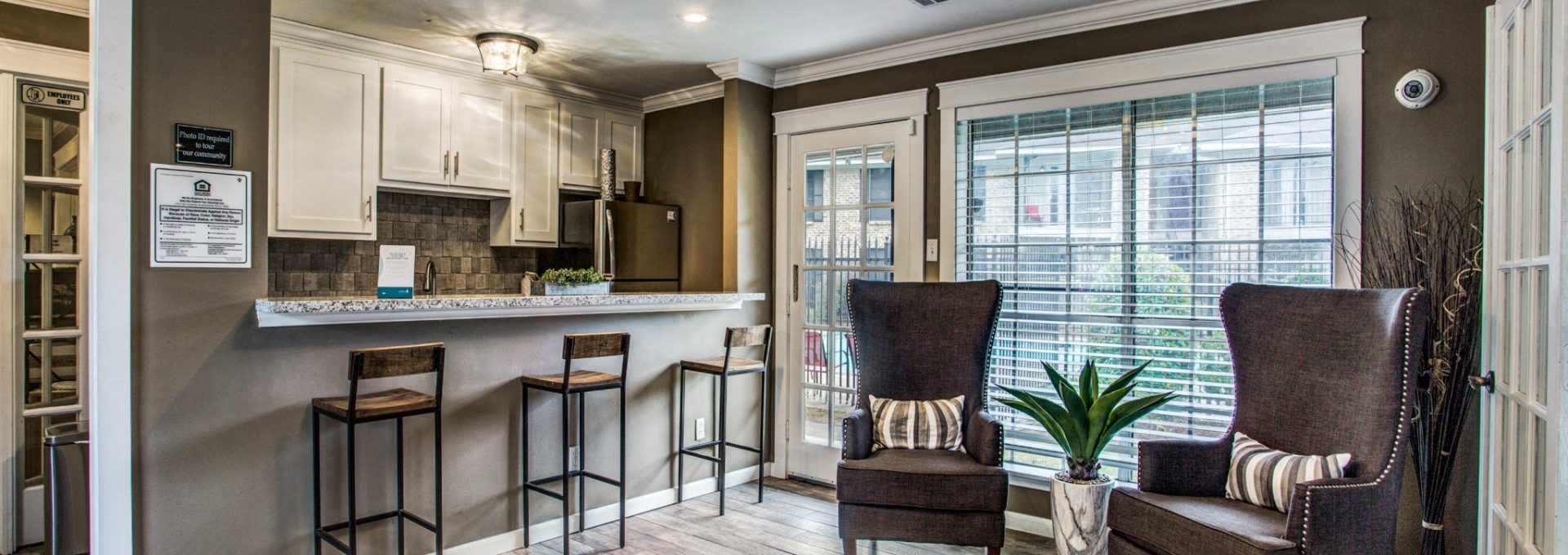 Renovated open-concept living room and kitchen with wood-style flooring at Clear Creek Landing in Houston, TX