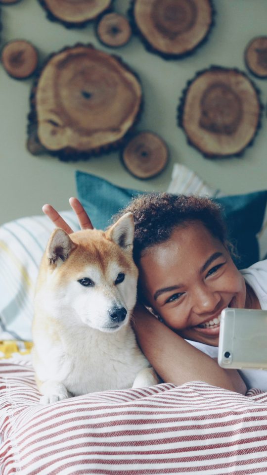 A woman takes a selfie with her dog.
