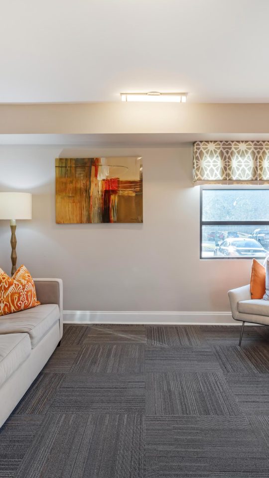 a living room with orange walls and a flat screen tv at The  Park at Fountain City