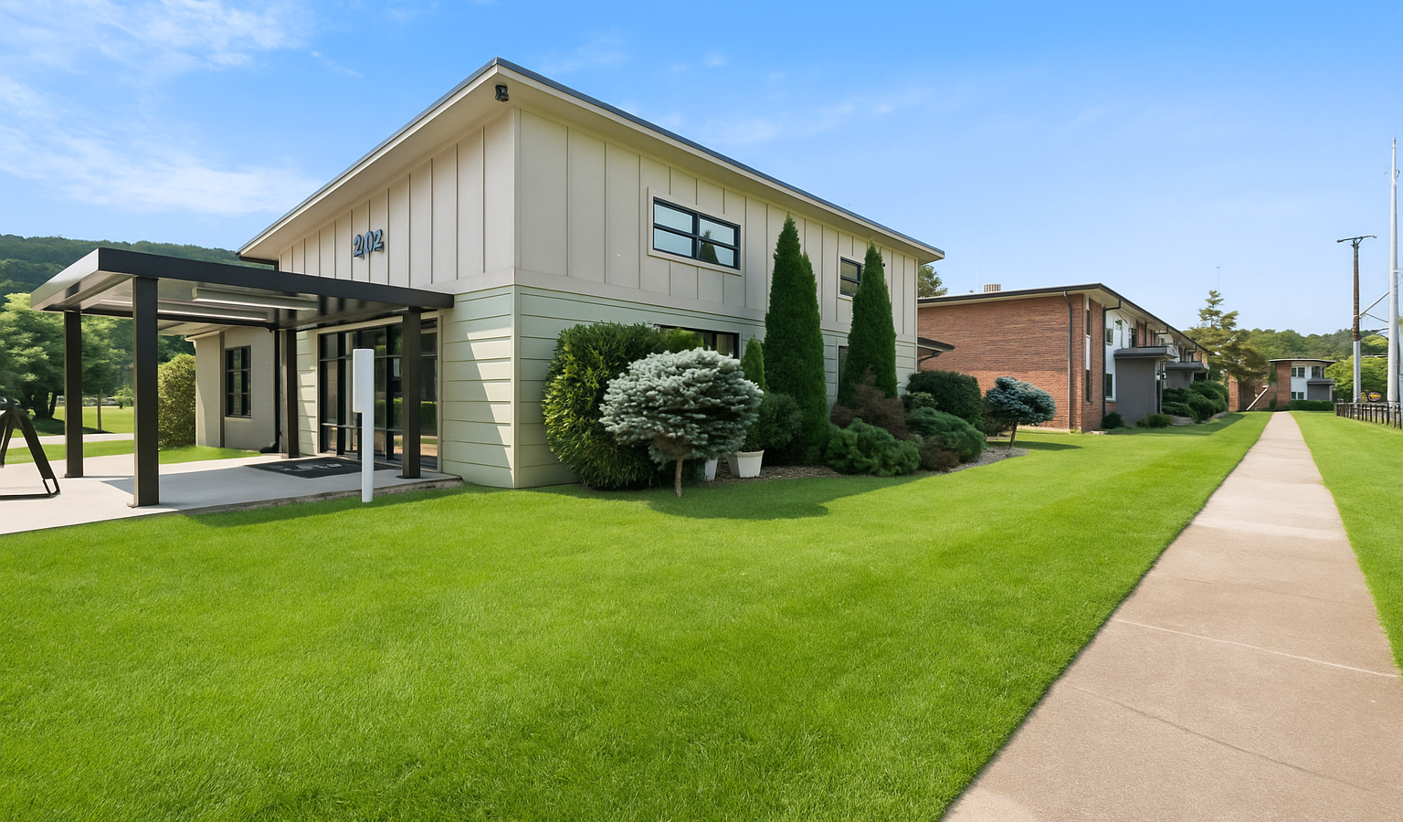 a large white house with a tree in front of it