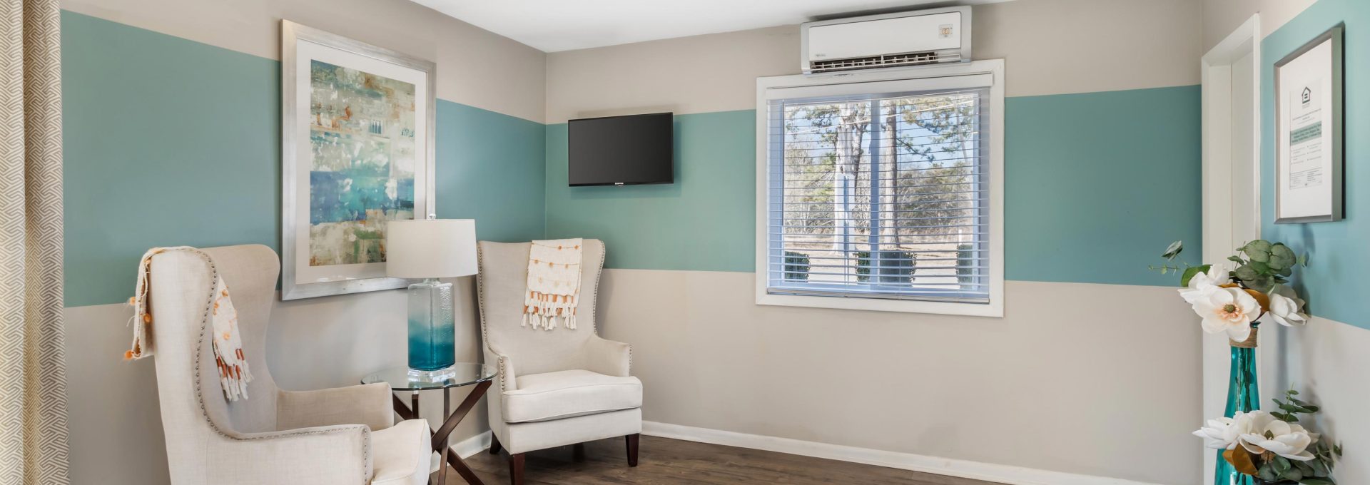 a living room with blue walls and white furniture at The North Park