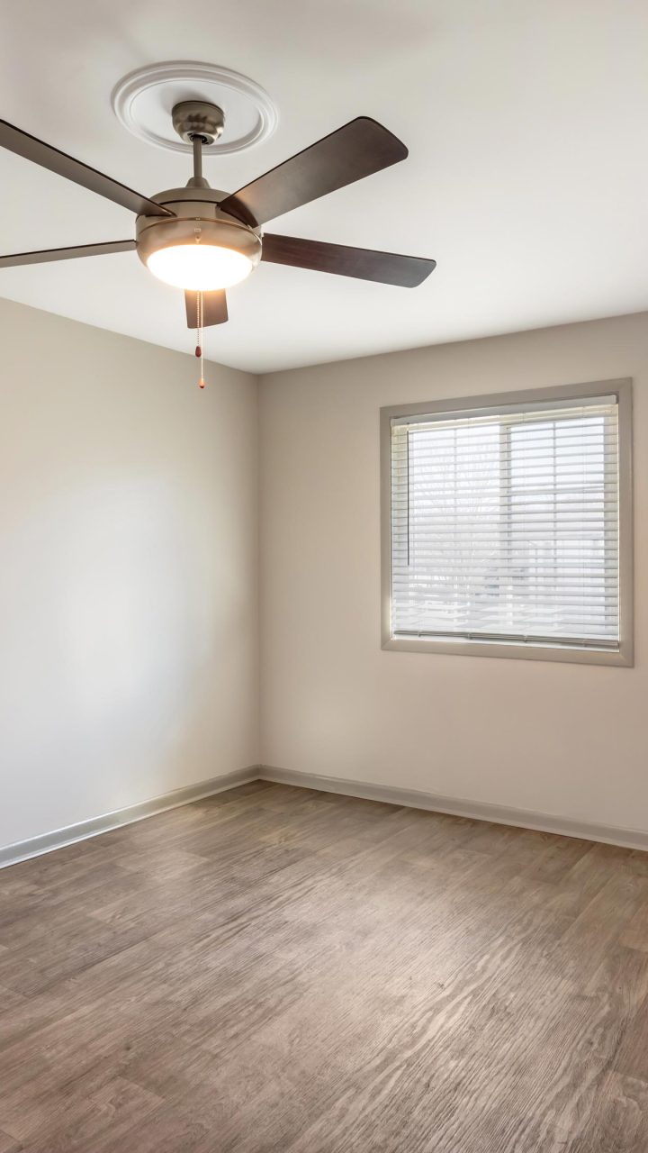 Bright apartment interior with wood-style flooring and a ceiling fan at North Park Apartments in Knoxville, Tennessee