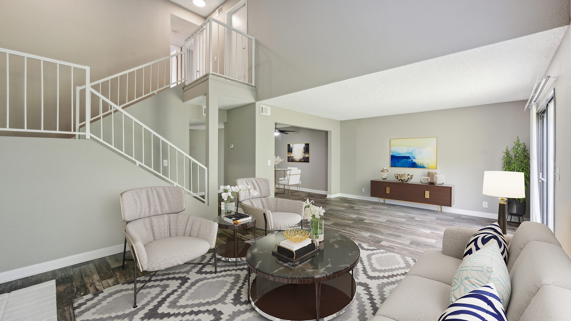 a living room with a staircase and a couch at The  Darby