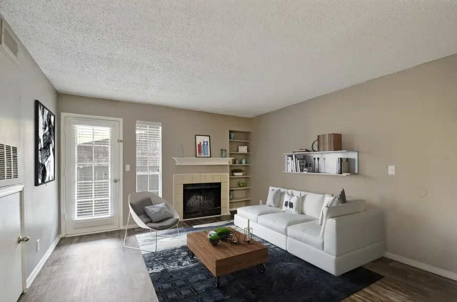 a living room with a fireplace and white furniture at The Hickory Highlands