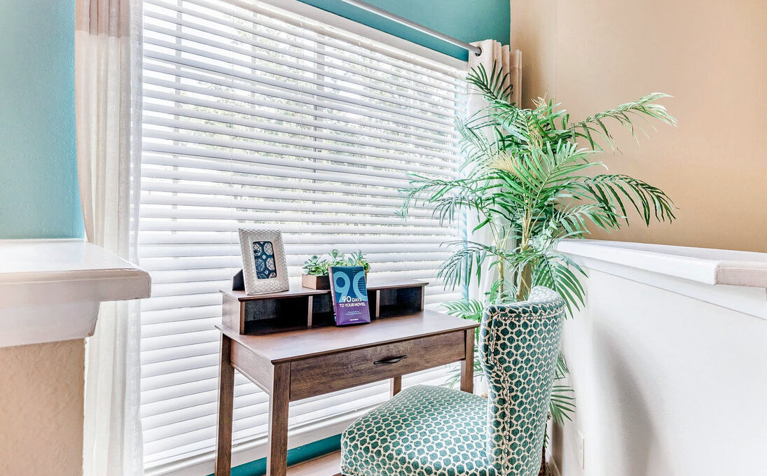 a desk with a chair and a plant in front of it at The Landmark At Gleneagles