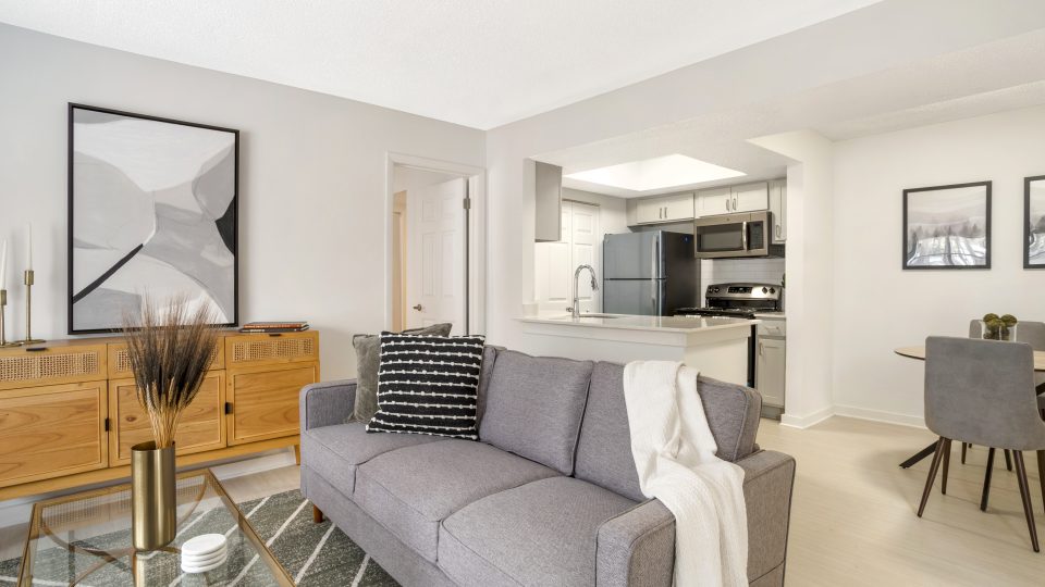 a living room with a couch, coffee table and television at The  Monte