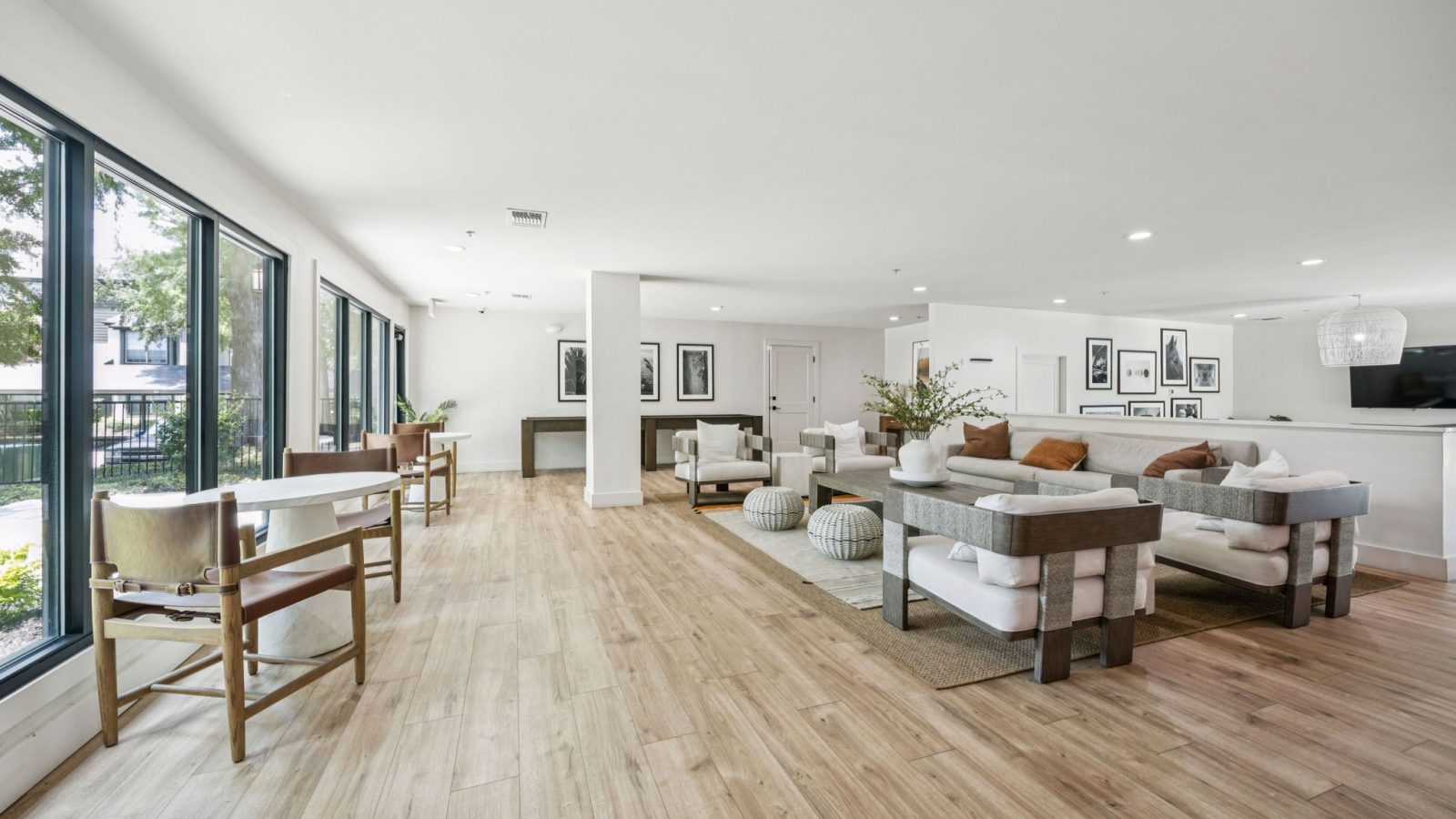 a large open living room with hardwood floors and large windows at The  Monte