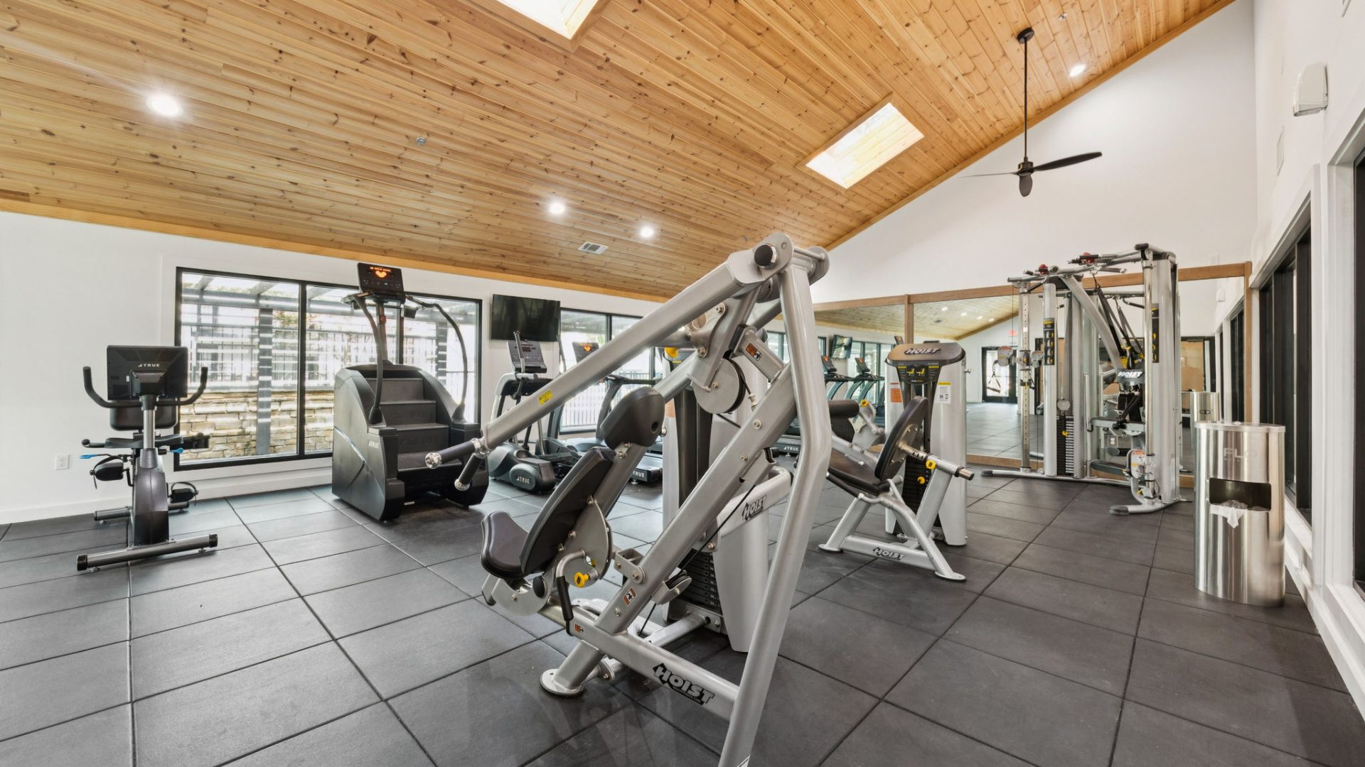 a gym room with a ceiling fan and exercise equipment at The  Monte