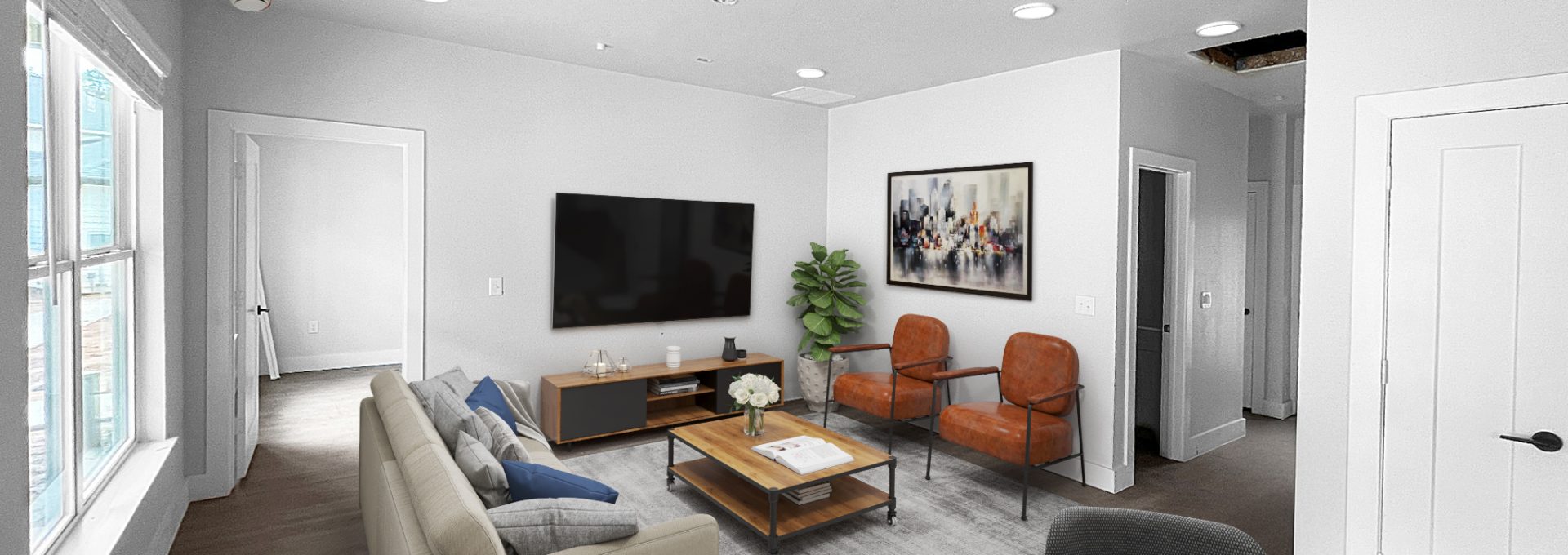 Two-Bedroom Luxury Apartments in Conroe, TX - Soltera Rolling Pines - Living Room with Wood Plank Flooring, Couch, Coffee Table, Armchairs, Wall-Mounted TV, Media Cabinet, and Wall Art.