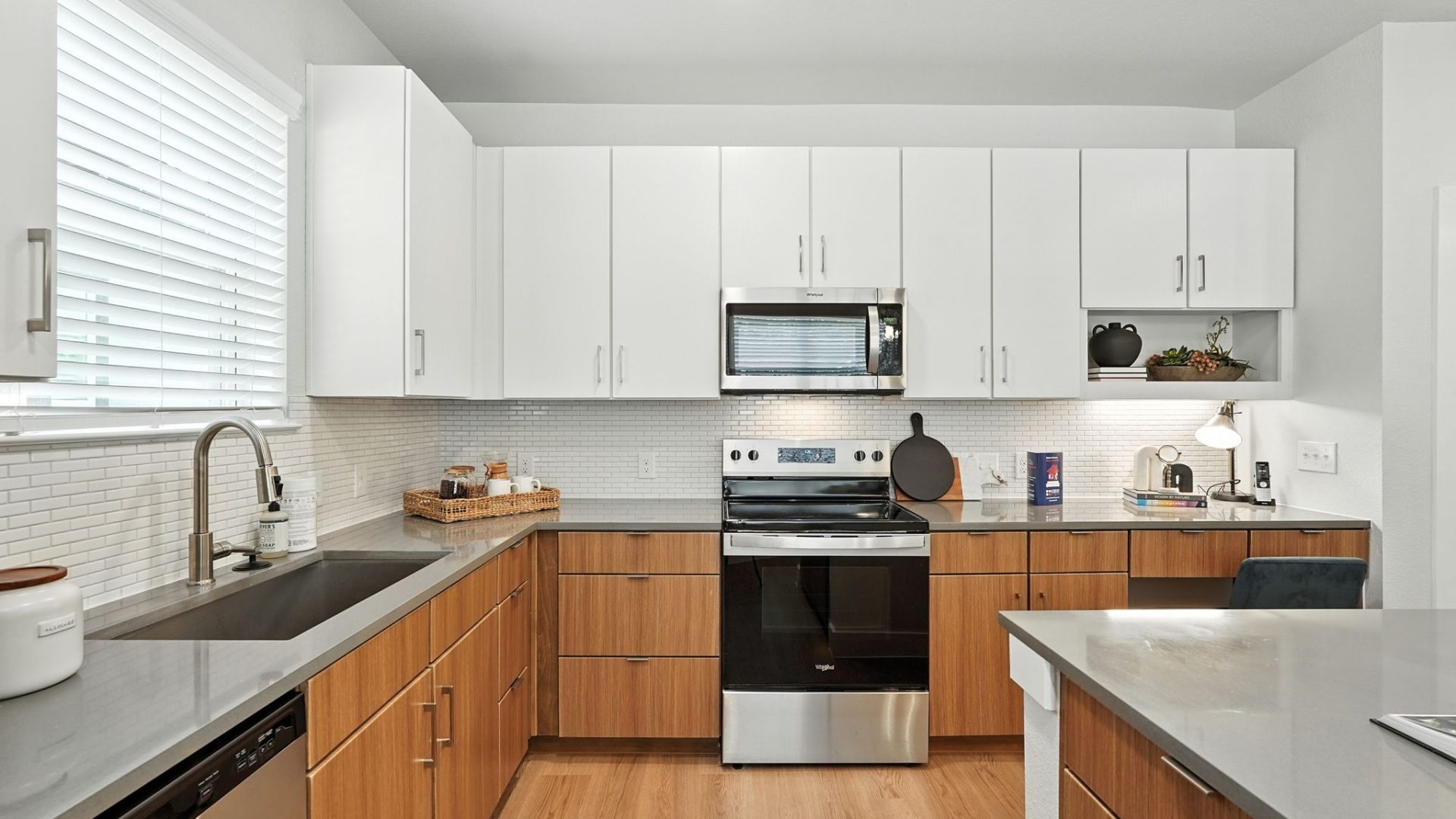Three-Bedroom Homes for Rent in Conroe, TX - Soltera Rolling Pines - Bright Modern Kitchen With White Cabinets, Stainless Steel Range, Subway Tile Backsplash, And Deep Sink.