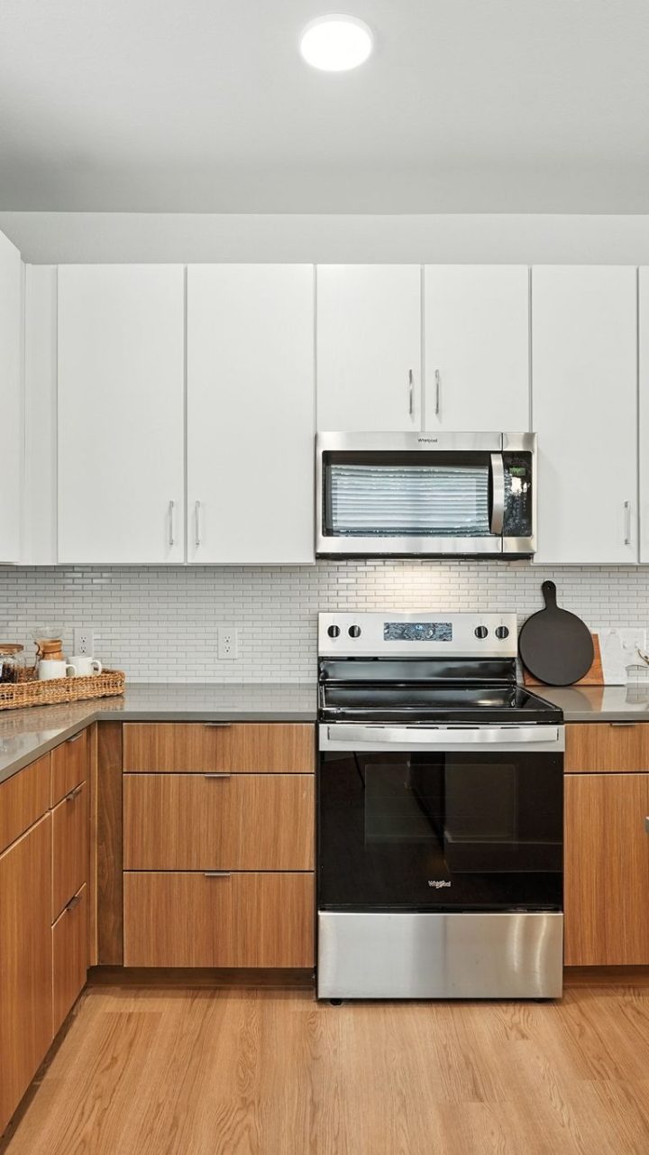 Three-Bedroom Homes for Rent in Conroe, TX - Soltera Rolling Pines - Bright Modern Kitchen With White Cabinets, Stainless Steel Range, Subway Tile Backsplash, And Deep Sink.