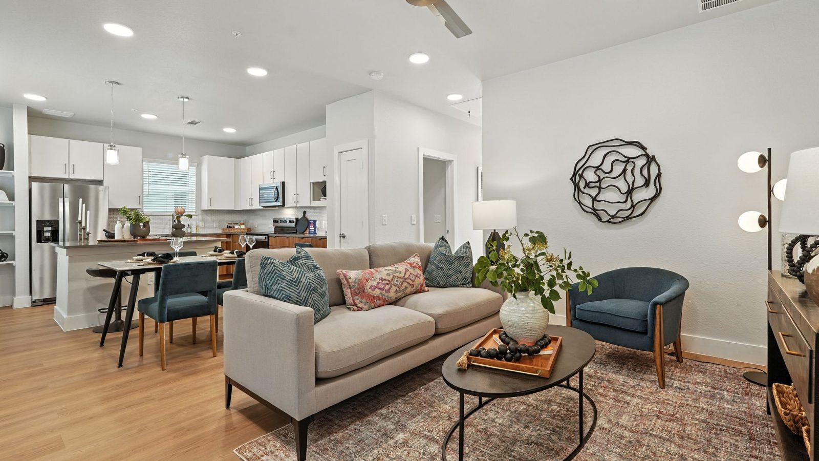 Conroe, TX, Homes for Rent with In-Unit Washer and Dryer - Soltera Rolling Pines - Open Concept Living Room And Kitchen With Sofa, Dining Table, Stainless Steel Appliances, And Pendant Lighting.