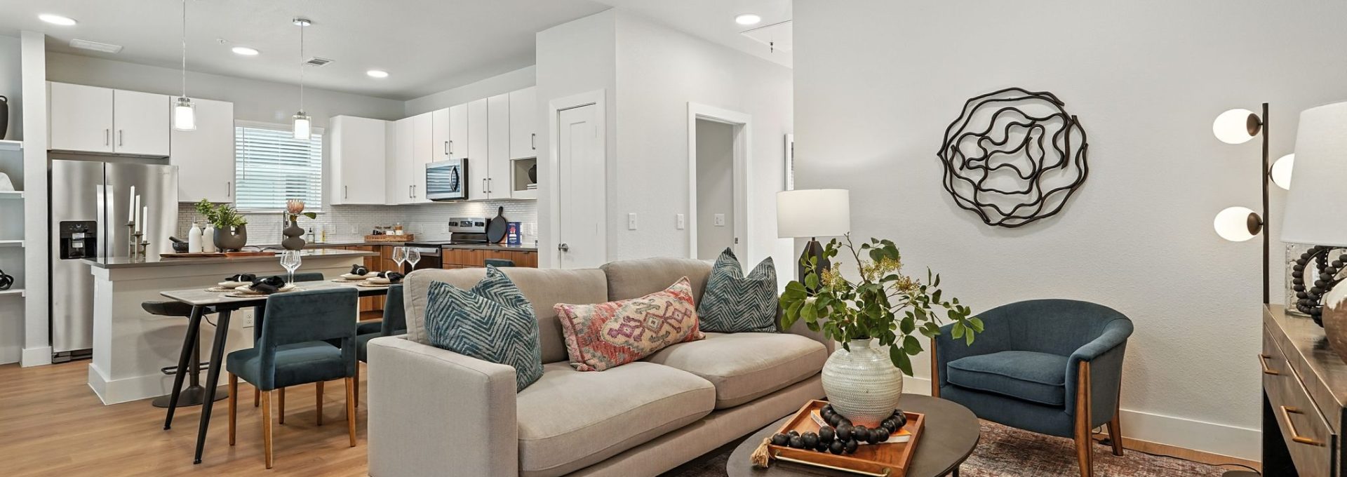 Conroe, TX, Homes for Rent with In-Unit Washer and Dryer - Soltera Rolling Pines - Open Concept Living Room And Kitchen With Sofa, Dining Table, Stainless Steel Appliances, And Pendant Lighting.