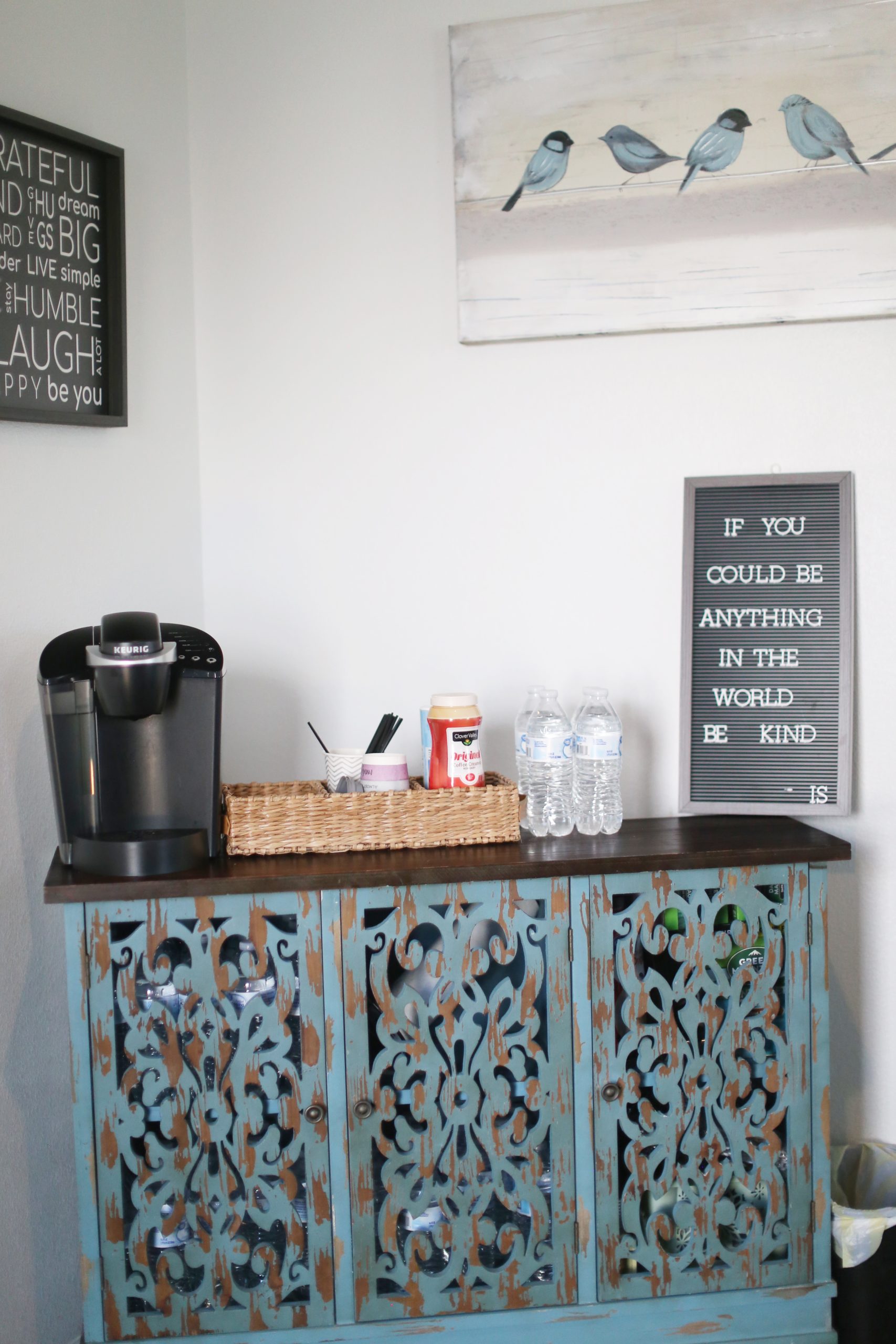 a coffee maker and a cabinet with a sign on it at The Vista Villa Apartments