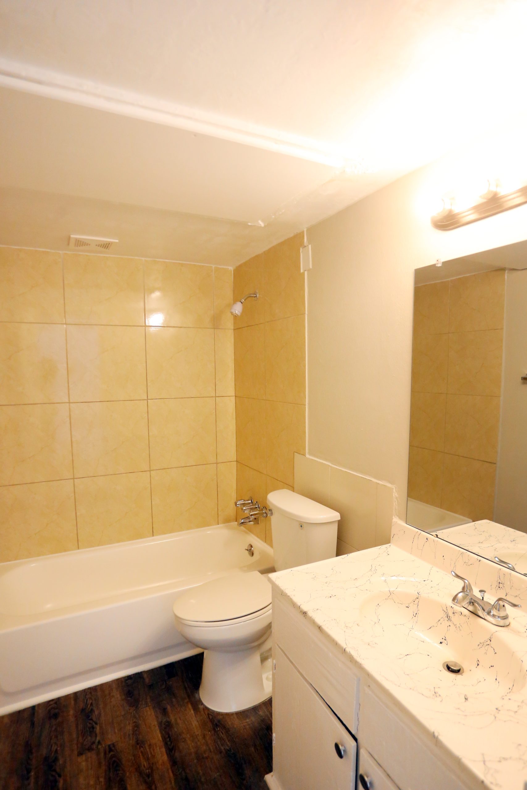 a bathroom with a tub, toilet and sink at The Vista Villa Apartments