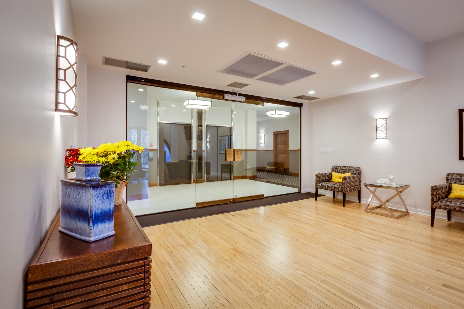 a clean and well lit lobby with wooden floors at The Germania Apartments