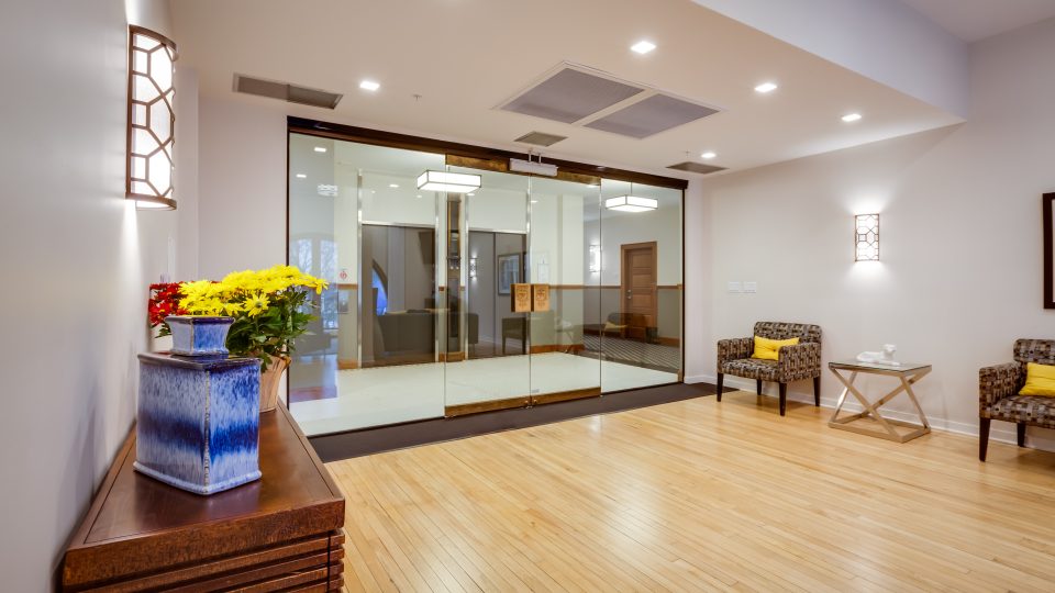 a clean and well lit lobby with wooden floors at The Germania Apartments