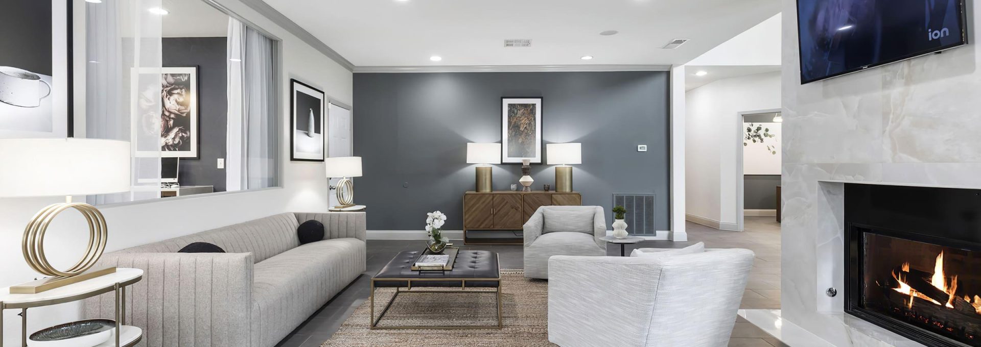 a living room with a fireplace and television at The  Adelene