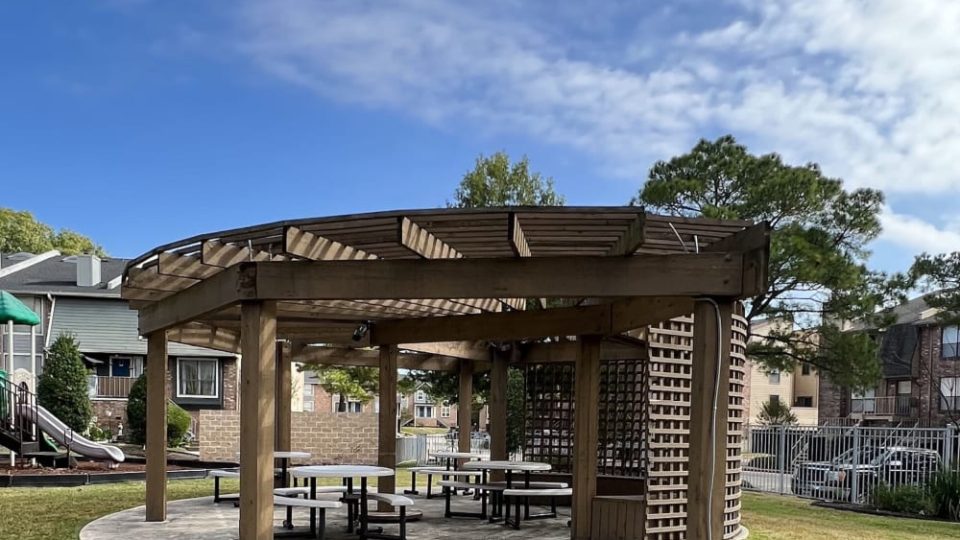 a gazebo with picnic tables and benches in the park at The Lakebridge Townhomes