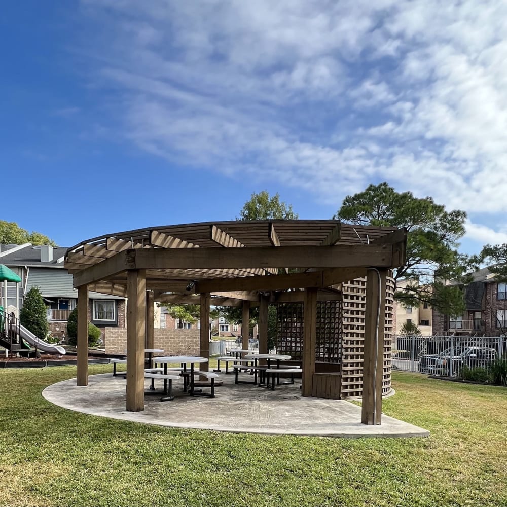 a gazebo with picnic tables and benches in the park at The Lakebridge Townhomes