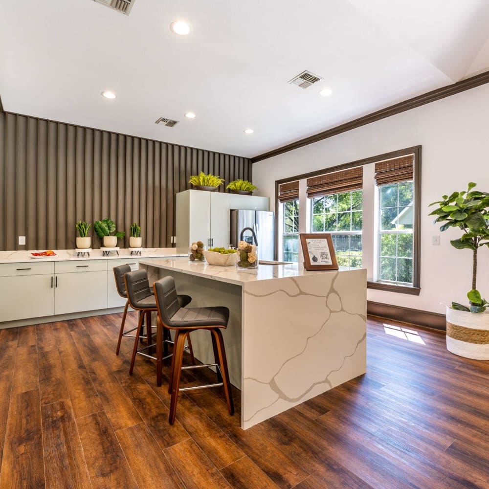 a kitchen with wood floors and a large island at The Pines on Spring Rain
