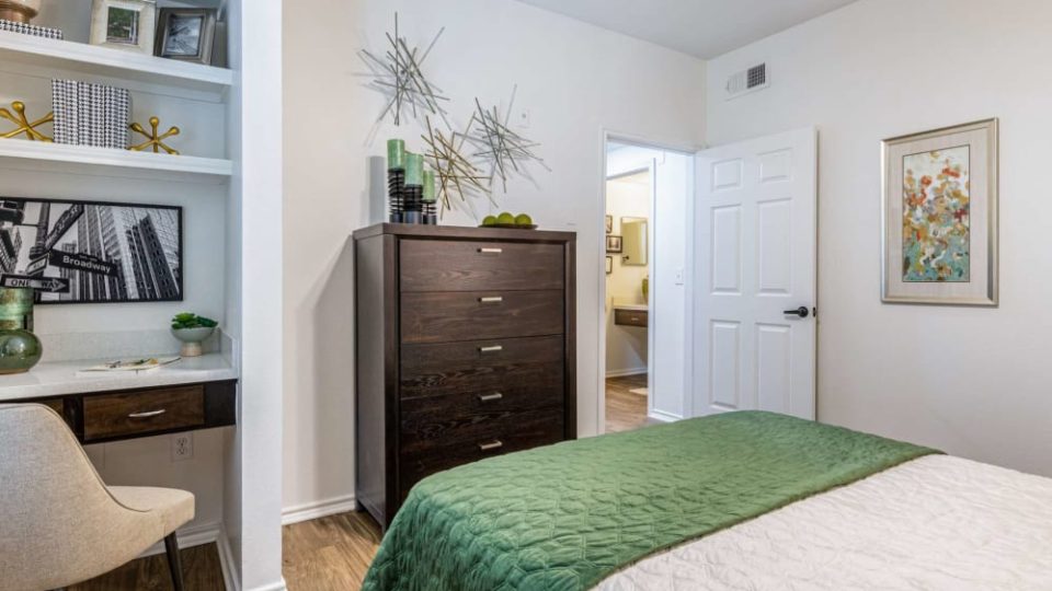 a bedroom with a green bed and white dresser at The  Pines on Spring Rain