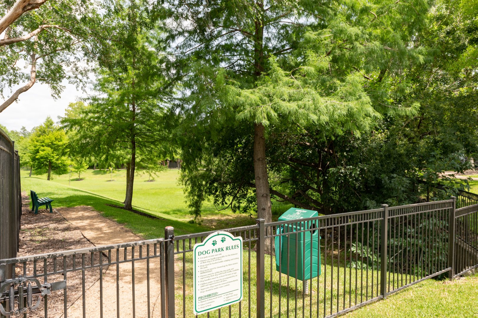 a park with a fence and trees in the background at The Boulevard at Deer Park