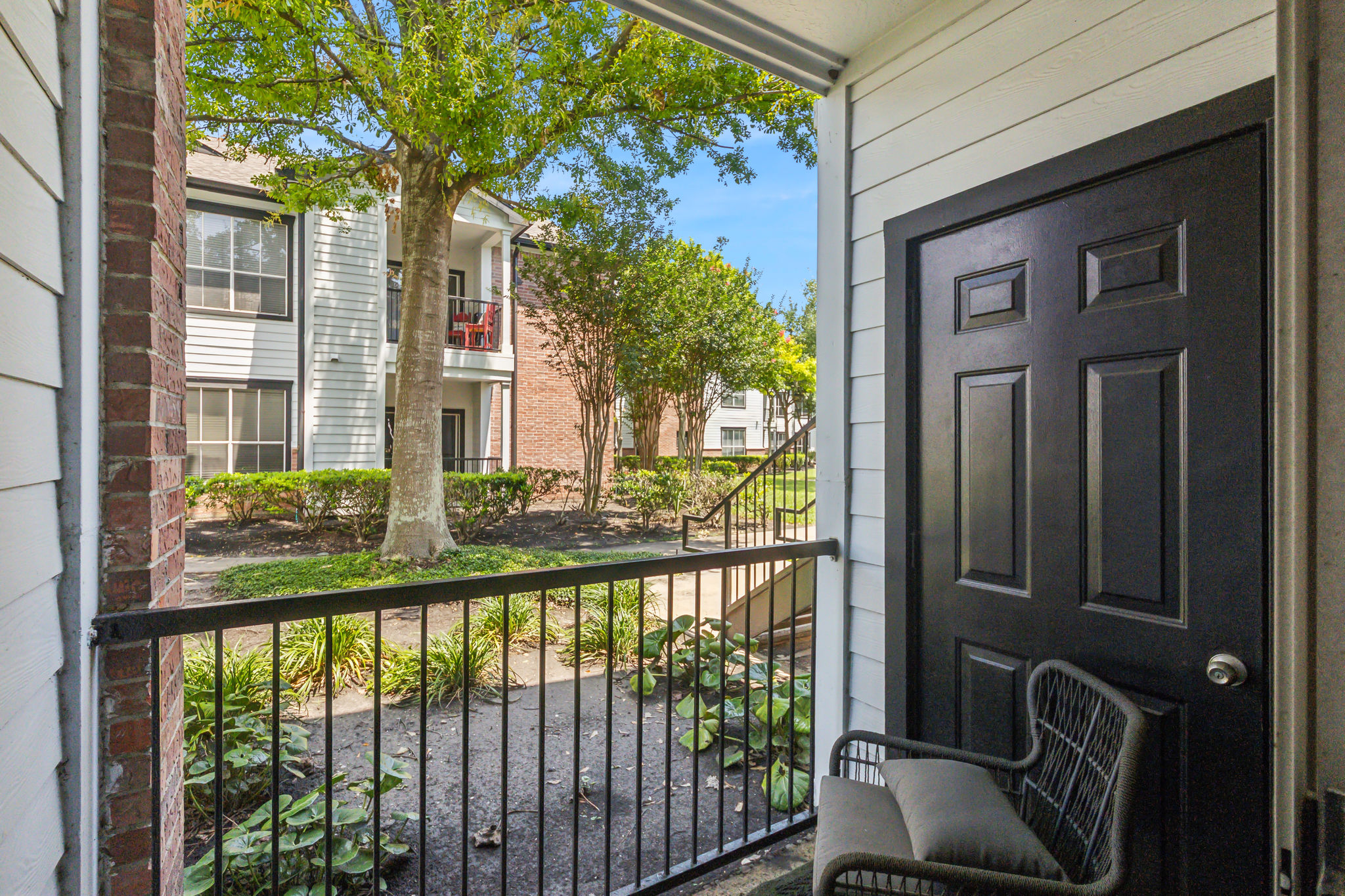 the balcony of a home with a view of trees and grass at The  Boulevard at Deer Park