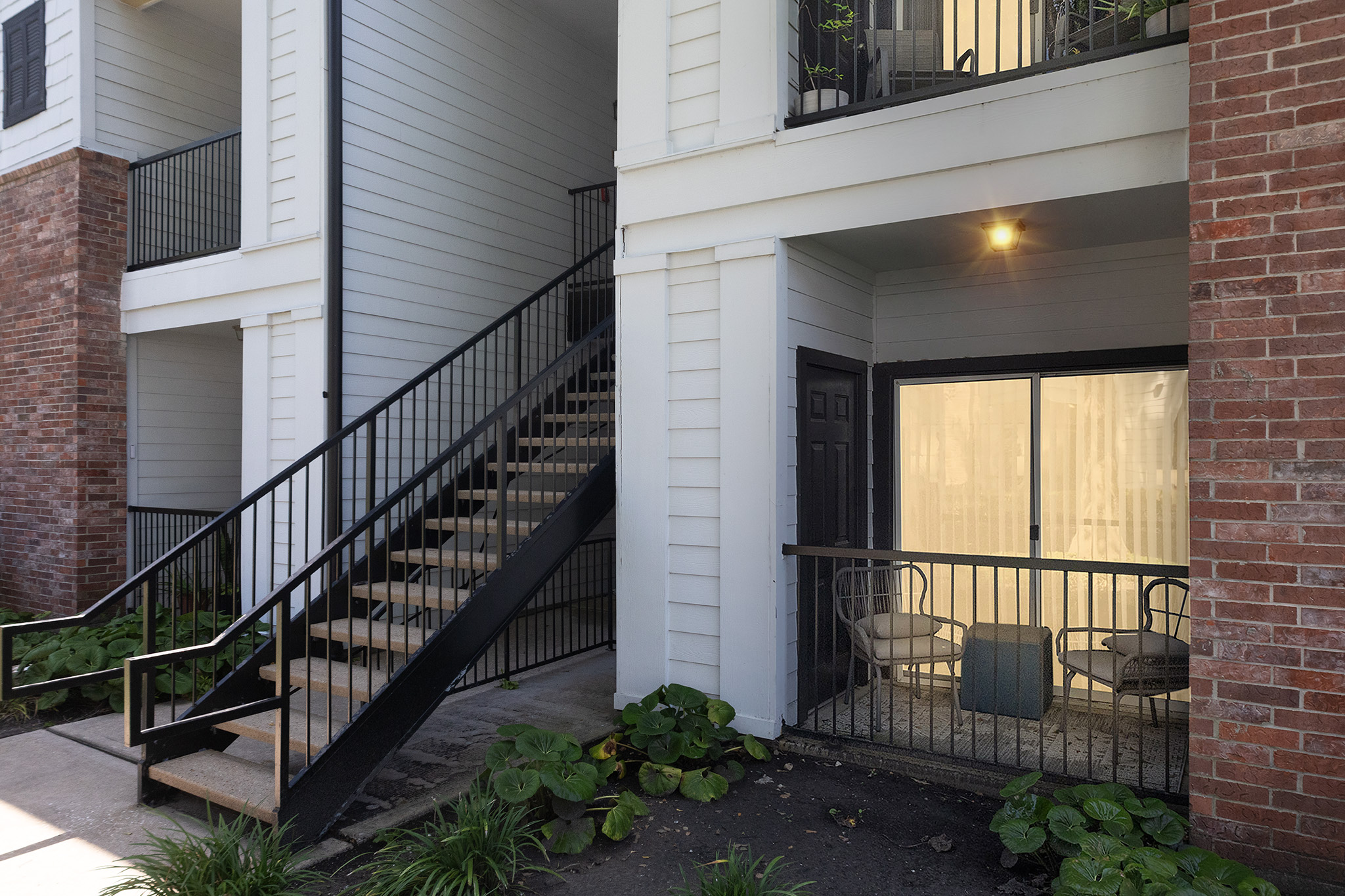 the balcony of an apartment building with stairs and railings at The  Boulevard at Deer Park
