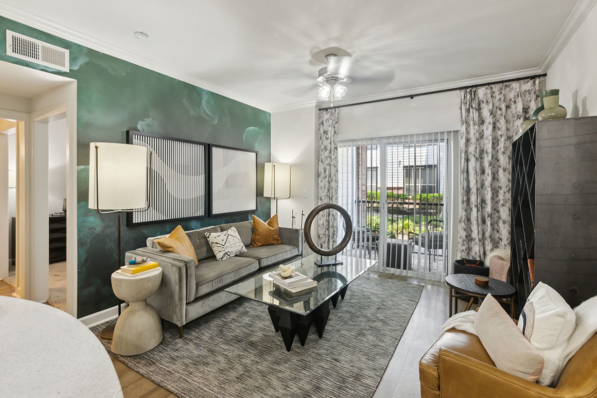 a living room with a green wall and a couch at The  Boulevard at Deer Park