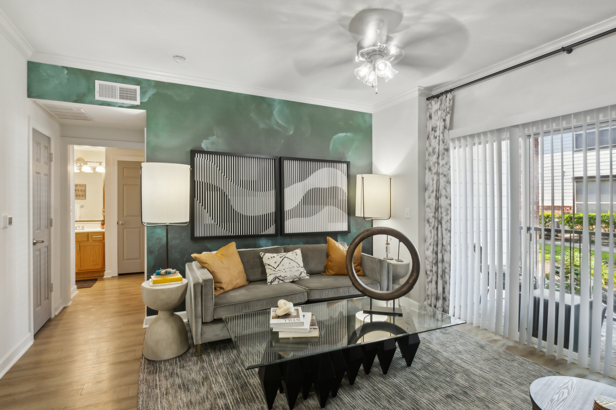 a living room with green walls and a green couch at The  Boulevard at Deer Park