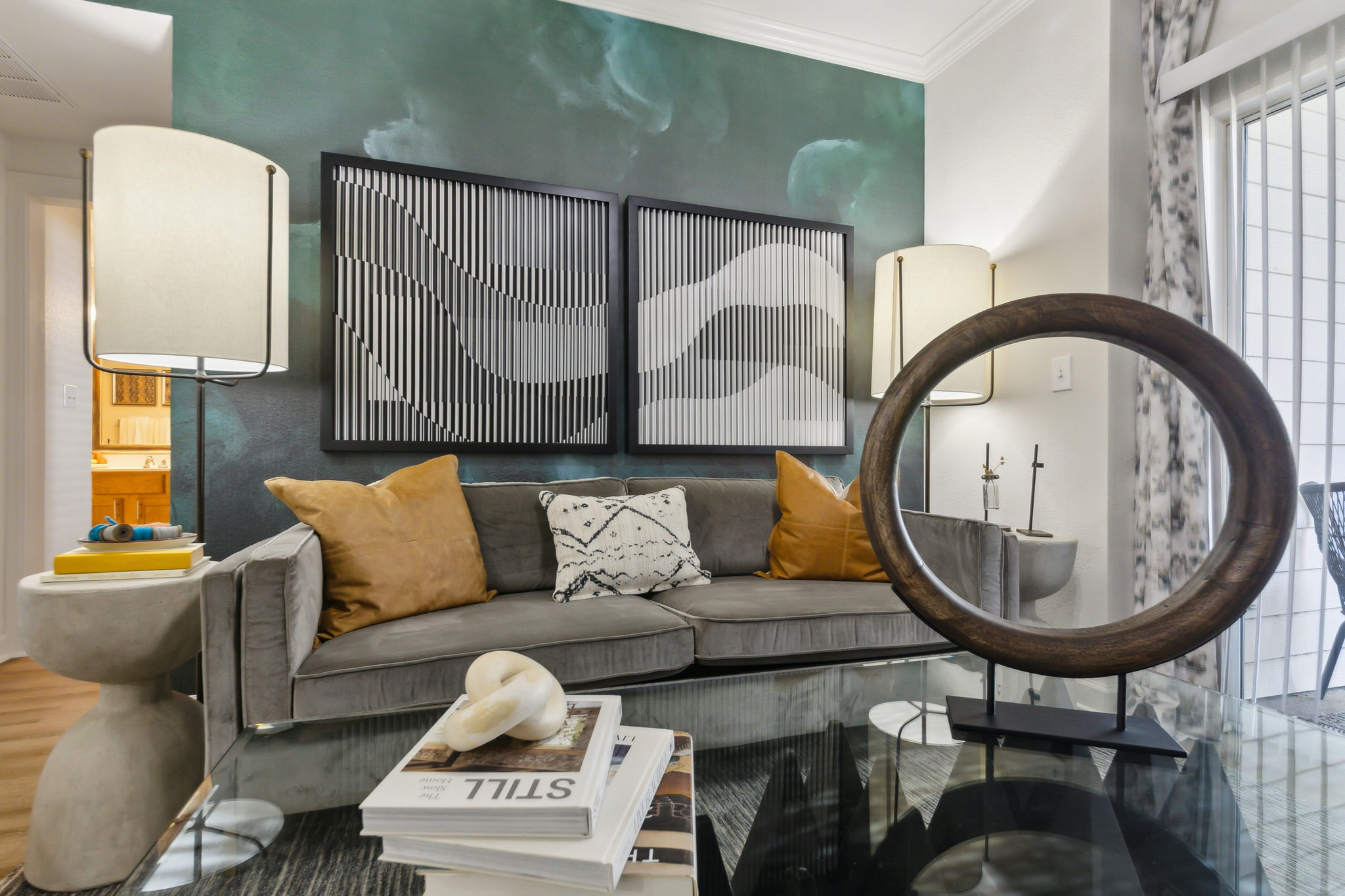a living room with a large mirror and a coffee table at The  Boulevard at Deer Park