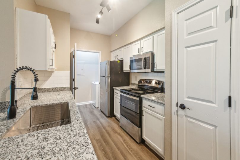 kitchen with granite counter tops and stainless steel appliances at The  Boulevard at Deer Park