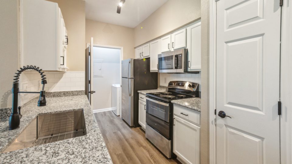 kitchen with granite counter tops and stainless steel appliances at The  Boulevard at Deer Park