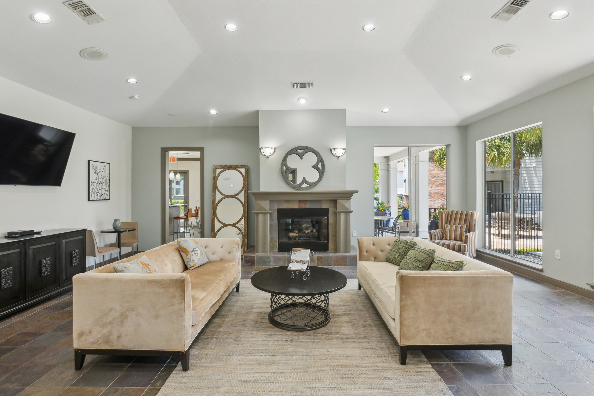 a living room with couches, a fireplace and a television at The  Boulevard at Deer Park