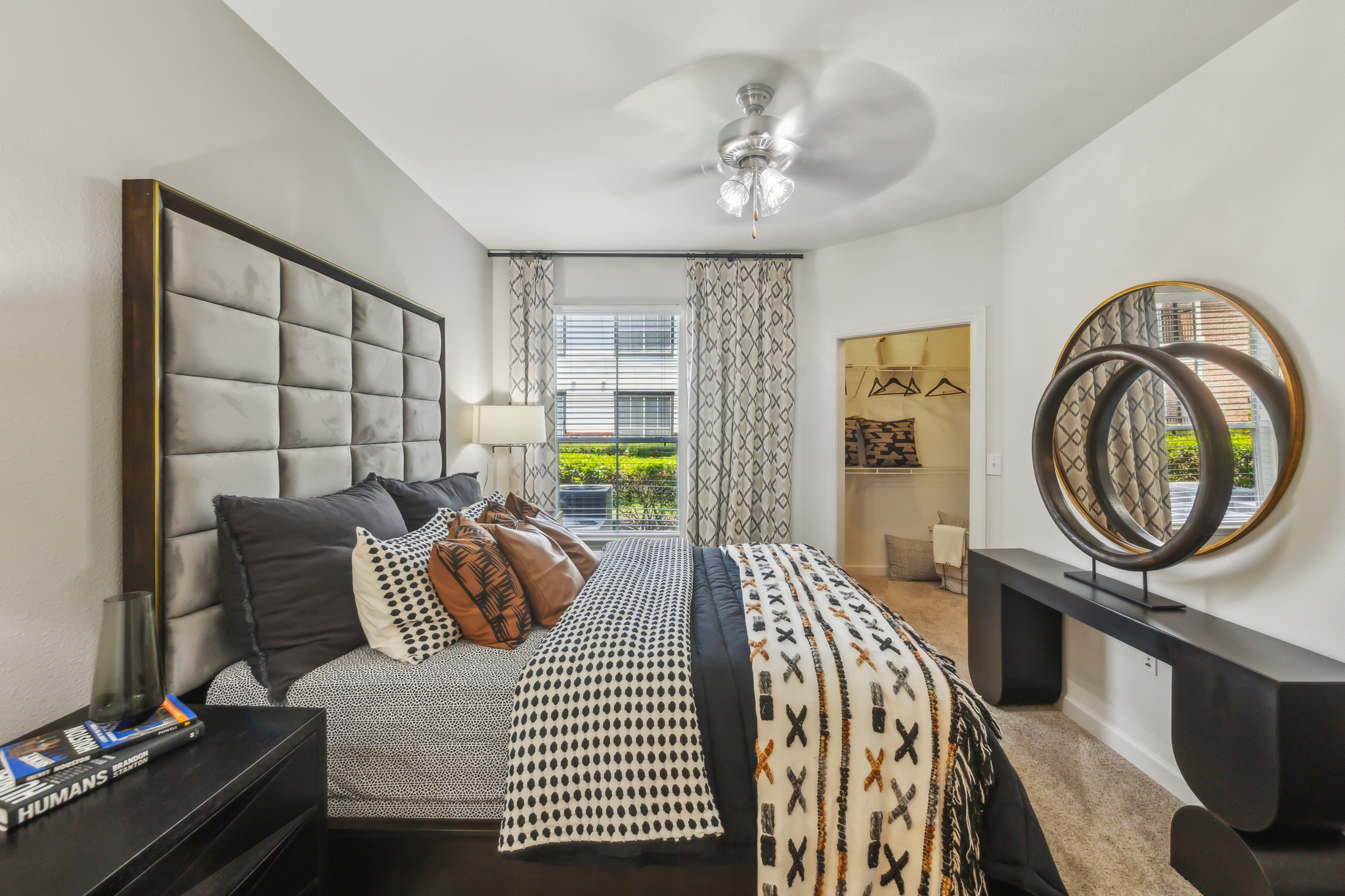 a bedroom with a bed, dresser and mirror at The  Boulevard at Deer Park