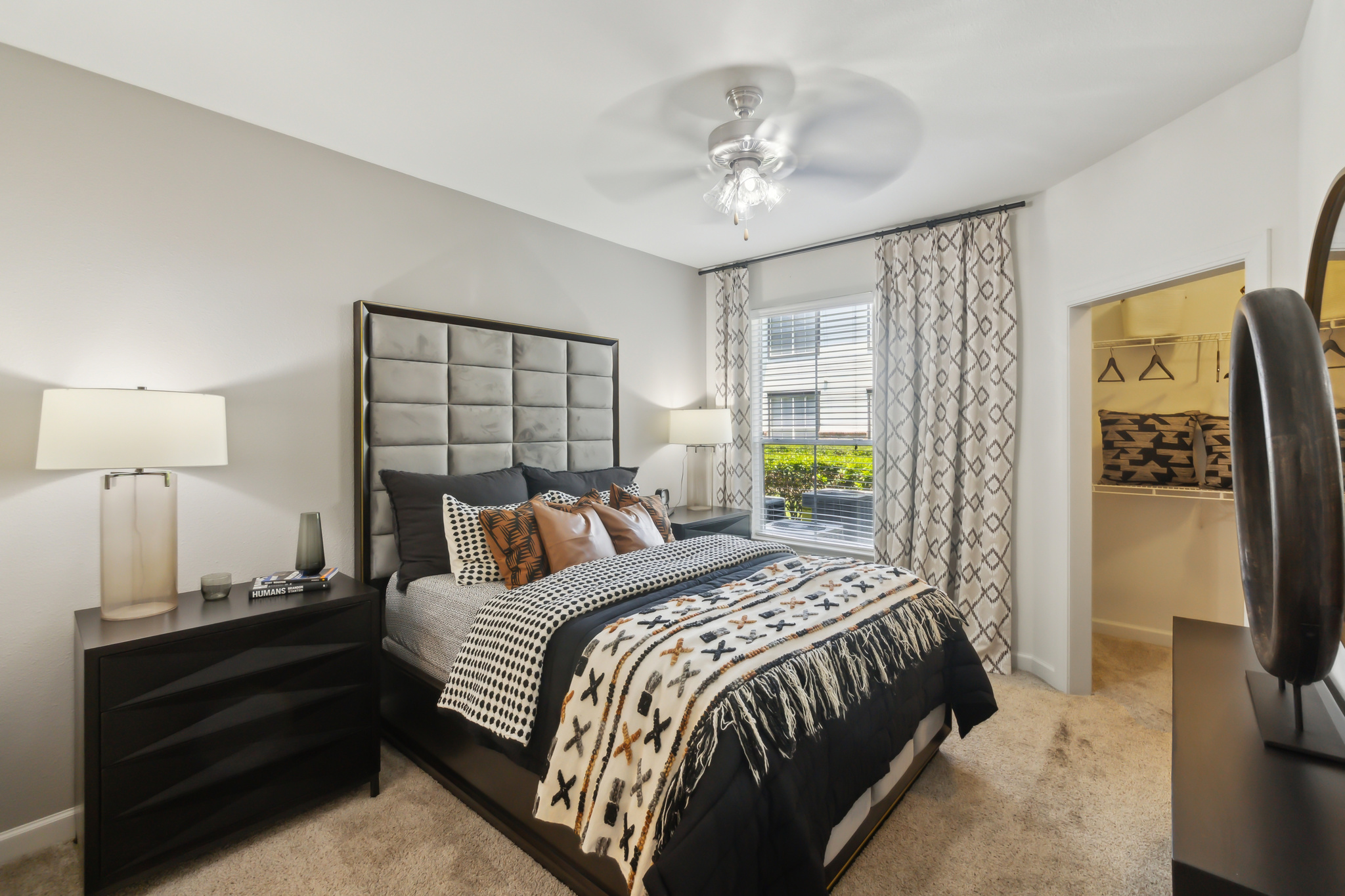 a bedroom with a bed, dresser and nightstand at The  Boulevard at Deer Park