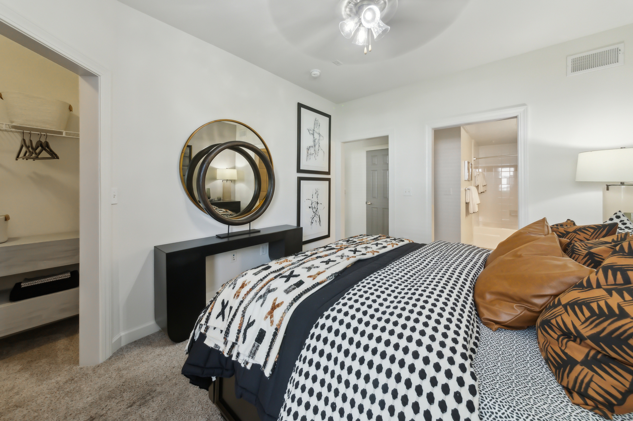 a bedroom with a bed, dresser and mirror at The  Boulevard at Deer Park
