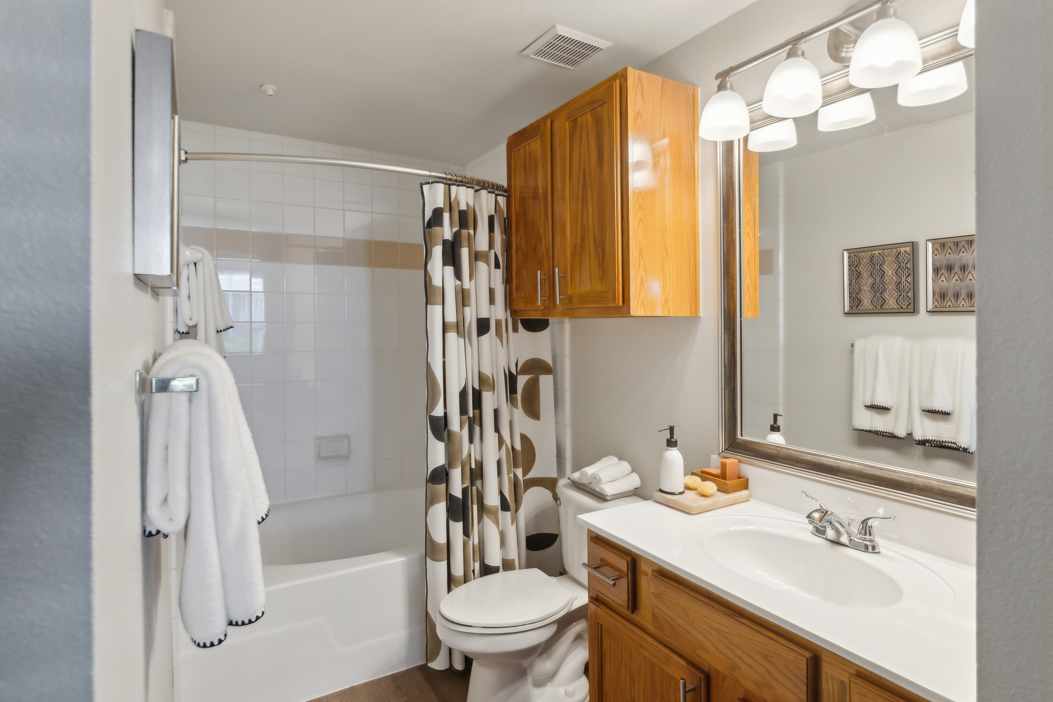 a bathroom with a shower and toilet and sink at The  Boulevard at Deer Park