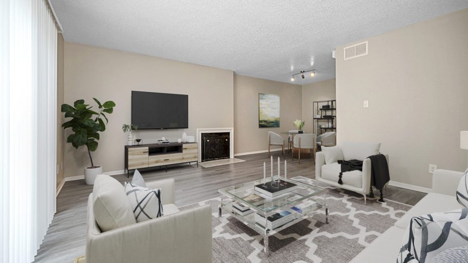 a living room with a fireplace and a television at The Windchase Flats and Townhomes